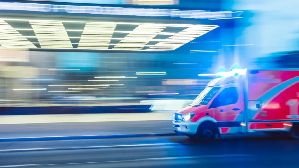 Ambulance qui roule à vive allure, gyrophares allumés