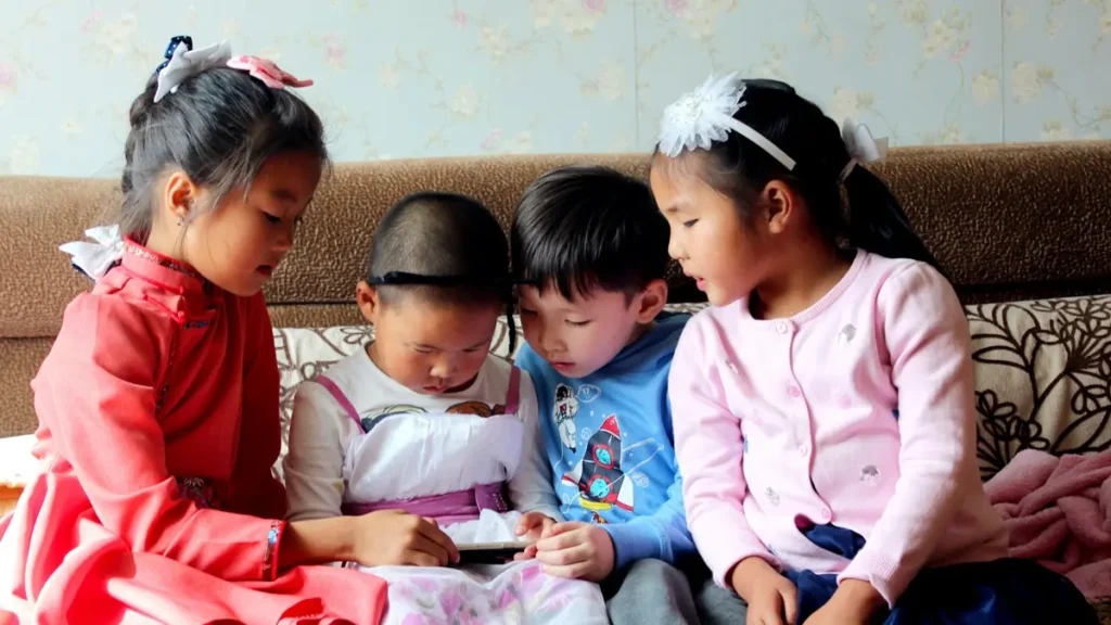 Quatre jeunes enfants assis sur un canapé