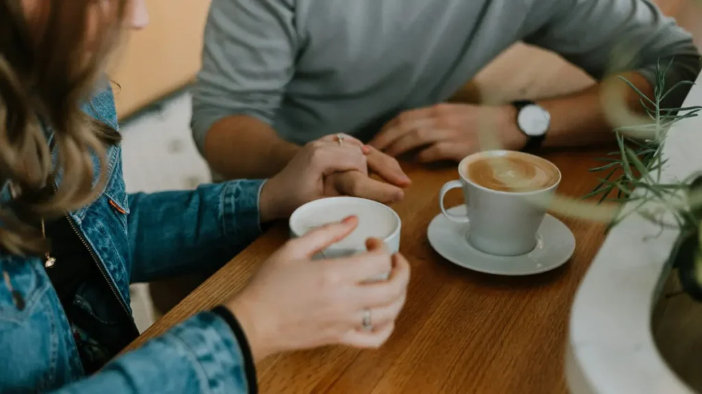 Deux personnes qui discutent autour d'un café